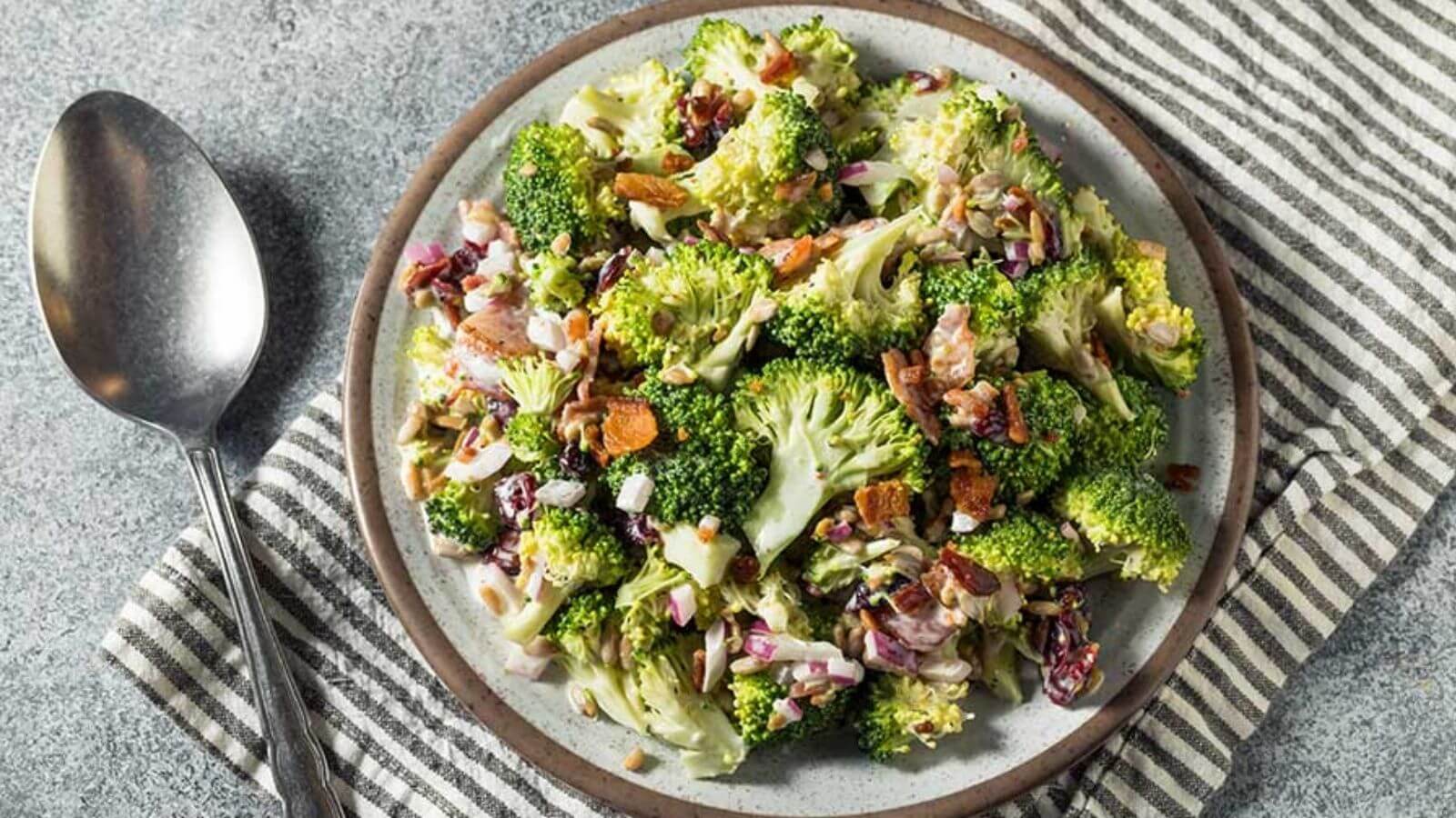 broccoli salad with bacon bits and raisins on a plate