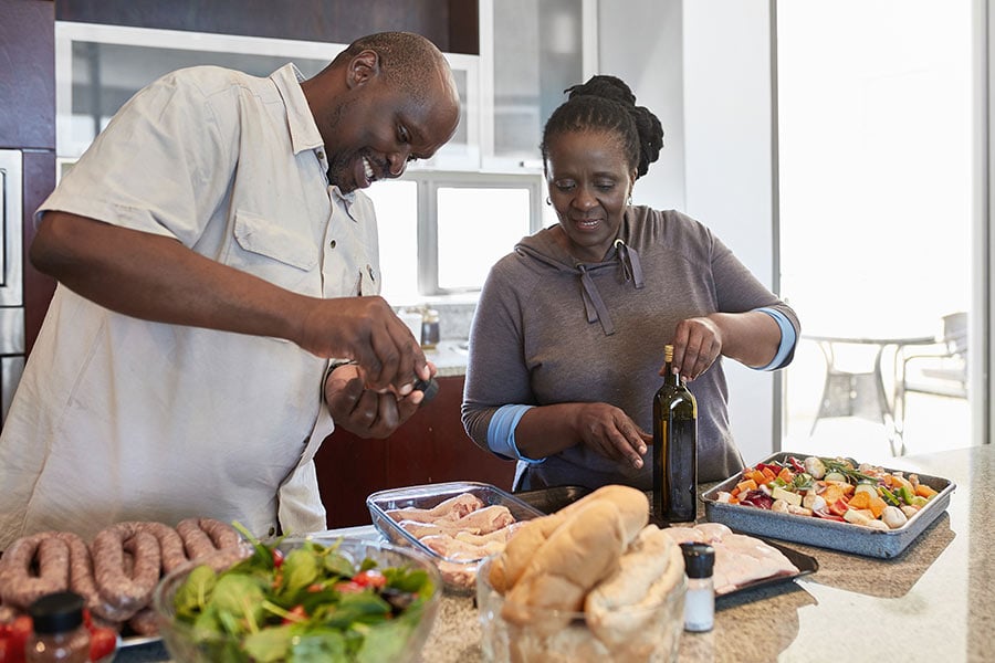 Couple preparing food in the kitchen for the balance Profile food plan.